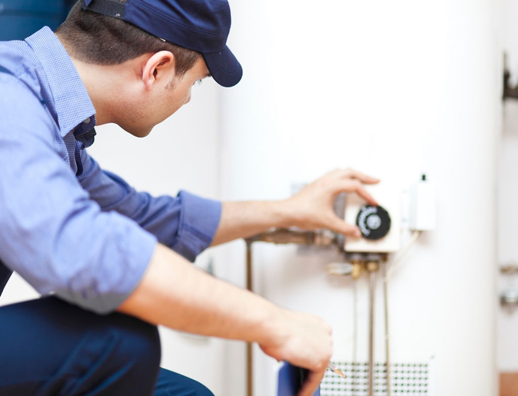 Plumber checks water heater Greenville Plumbing Pros
